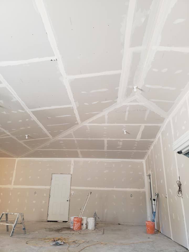 Taping and mudding is complete in high ceilinged garage.  Ready for painting